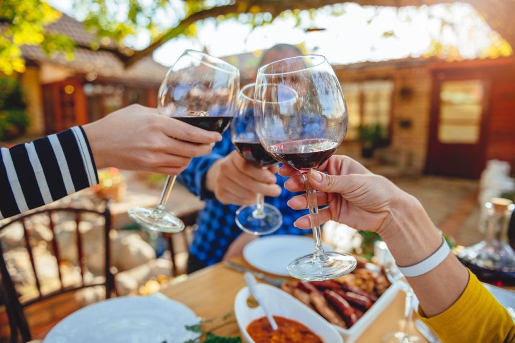 People doing cheers with wine glass