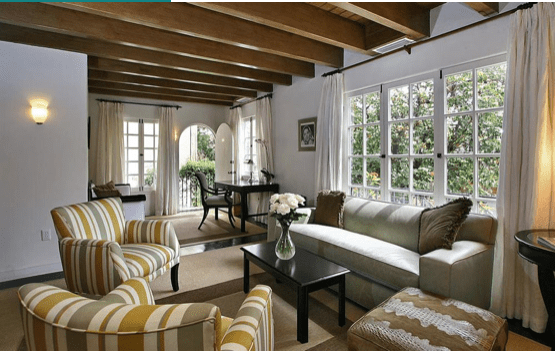 Interior of a house with a big window and a sofa set