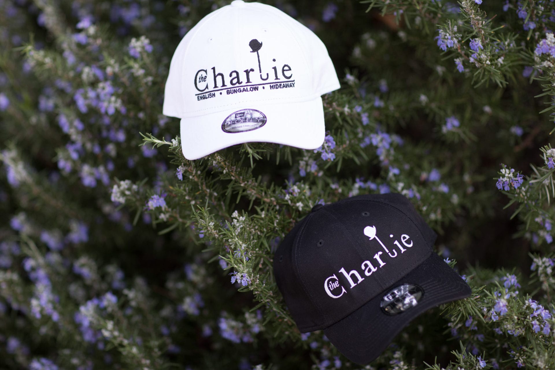 Two hats with the word Charlie Hotel on them.