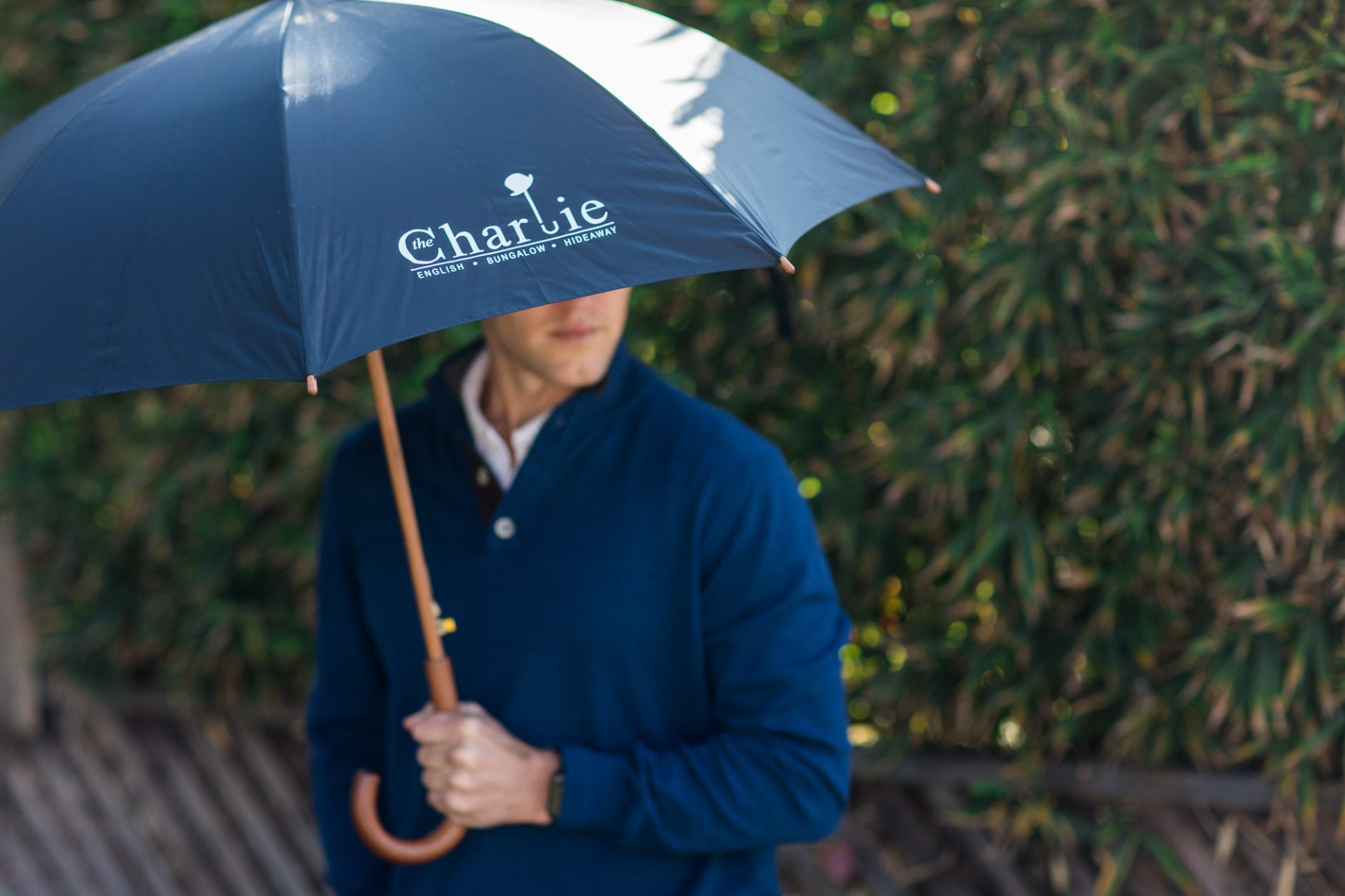 A man holding an umbrella with "Chloe" written on it.