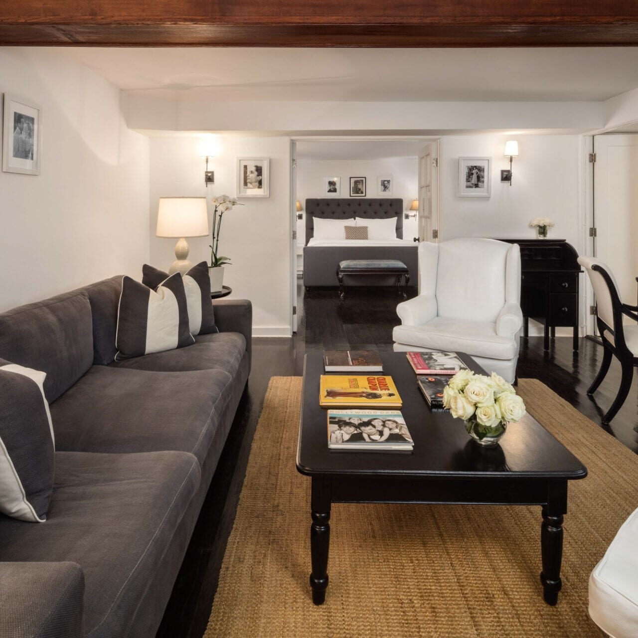 The Charlie Hotel offers a cozy living room with a couch, coffee table, and TV.