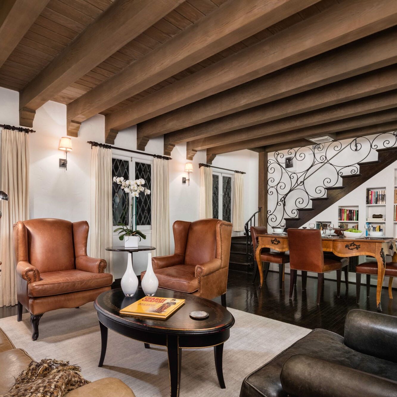 The Charlie Hotel is a living room with wooden beams and leather furniture.