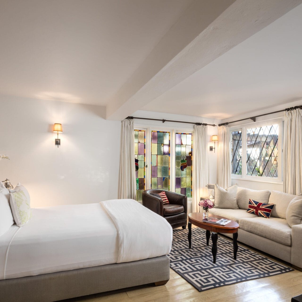 The Charlie Hotel is equipped with a bedroom featuring a large bed and a couch.